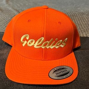 “Goldie’s” snap back hat.